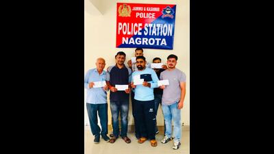 Some of the victims with their refund cheques. (HT) Some of the victims with their refund cheques. (HT)