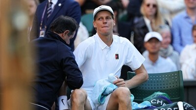 Jannik Sinner reacts as he receives medical treatment during his men's singles fourth round tennis match against Grigor Dimitrov on the eighth day of the 2025 Wimbledon (AFP) Jannik Sinner reacts as he receives medical treatment during his men's singles fourth round tennis match against Grigor Dimitrov on the eighth day of the 2025 Wimbledon (AFP)