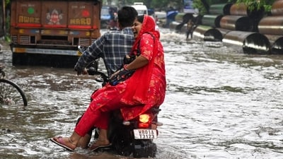 A couple on a motorbike can be seen enjoying a rainy ride through a waterlogged street in Kolkata on Tuesday. (HT Photo/Samir Jana) A couple on a motorbike can be seen enjoying a rainy ride through a waterlogged street in Kolkata on Tuesday. (HT Photo/Samir Jana)