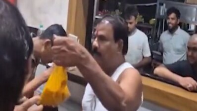 Sanjay Gaikwad, from the Shiv Sena of deputy CM Eknath Shinde, holding up the "stale" dal as he goes on to slap a staff member at the MLA Hostel canteen in Mumbai. (Video grab/X/@SilentEyes0106) Sanjay Gaikwad, from the Shiv Sena of deputy CM Eknath Shinde, holding up the "stale" dal as he goes on to slap a staff member at the MLA Hostel canteen in Mumbai. (Video grab/X/@SilentEyes0106)