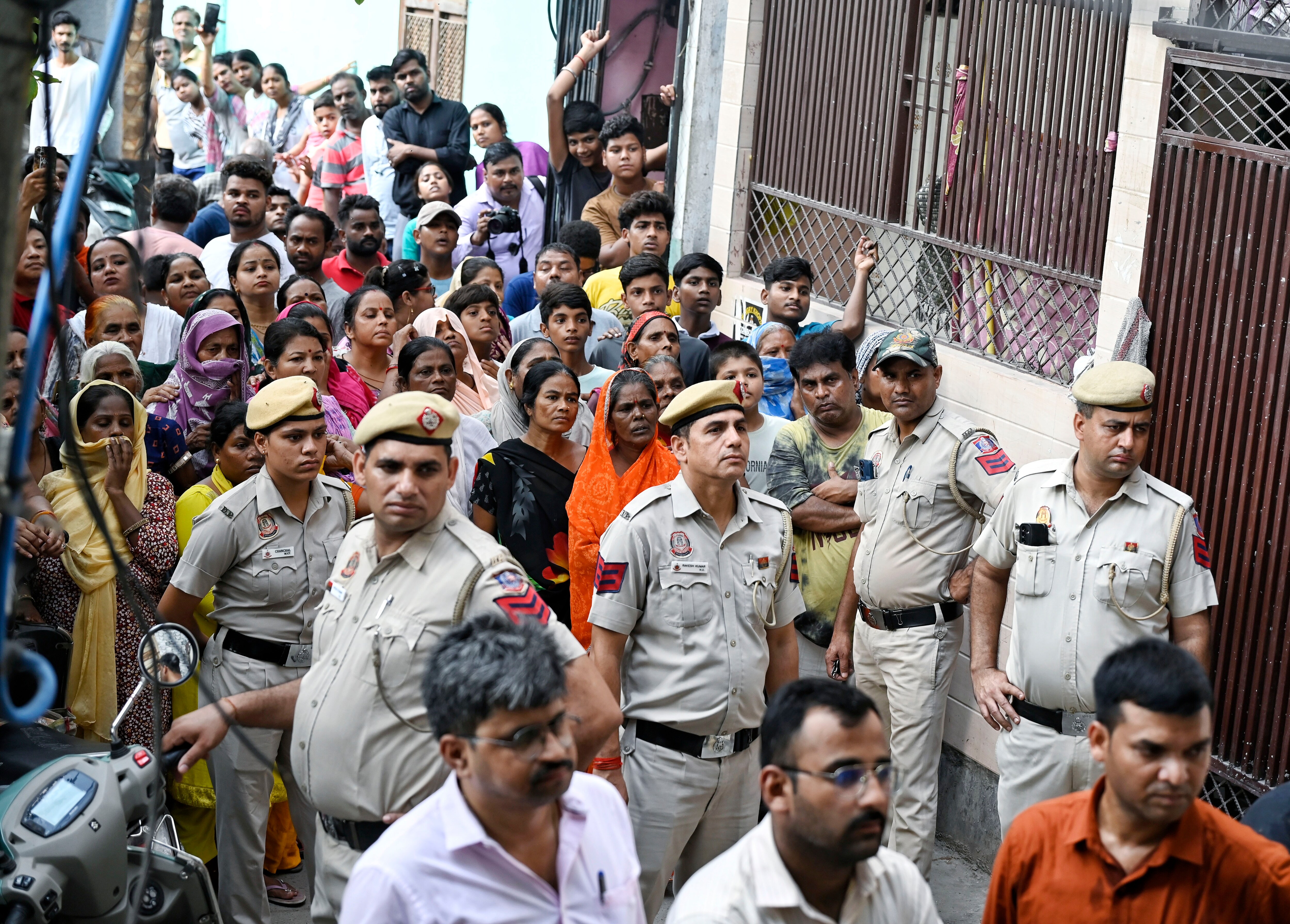 People and Police personnel at the site after a woman named Sonal and an infant (her friend's daughter) were found stabbed to death in the Majnu Ka Tila area, in New Delhi on Tuesday. (ANI) People and Police personnel at the site after a woman named Sonal and an infant (her friend's daughter) were found stabbed to death in the Majnu Ka Tila area, in New Delhi on Tuesday. (ANI)