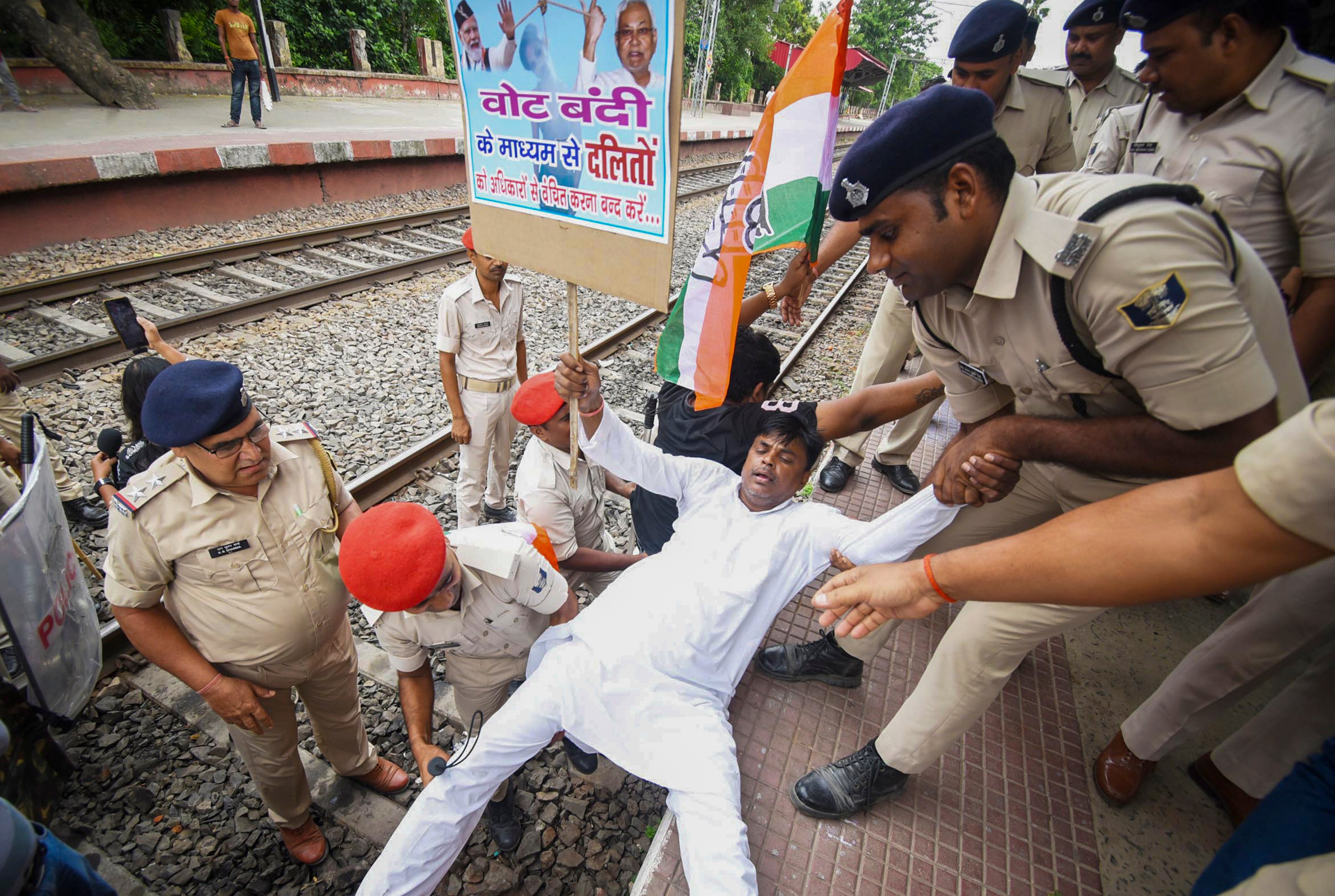 An agitator being detained during a protest by Congress workers and supporters amid 'Bihar bandh' called by the INDIA bloc against the voter lists' Special Intensive Revision in the state, near a train station in Patna on July 9. (PTI) An agitator being detained during a protest by Congress workers and supporters amid 'Bihar bandh' called by the INDIA bloc against the voter lists' Special Intensive Revision in the state, near a train station in Patna on July 9. (PTI)