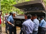 Personnel from the Centre for Legal Medicine and Forensic Sciences carry the coffin with the remains of Francisco Martinez, mayor of the San Isidro municipality, in Tegucigalpa on July 10
