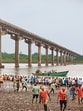 Rescuers and locals look for survivors after the collapse of a portion of a bridge in Gujarat (AP) Rescuers and locals look for survivors after the collapse of a portion of a bridge in Gujarat (AP)