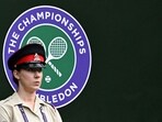 A security guard stands on Centre Court during the men's singles quarter-final tennis match