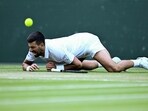 Serbia's Novak Djokovic falls as he plays against Italy's Flavio Cobolli during their men's singles quarter-final tennis match on the tenth day of the 2025 Wimbledon Serbia's Novak Djokovic falls as he plays against Italy's Flavio Cobolli during their men's singles quarter-final tennis match on the tenth day of the 2025 Wimbledon