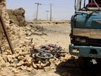 A general view shows damaged vehicles at the site a day after a bomb blast in Qila Abdullah, in Balochistan province, on May 19, 2025. 