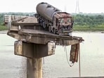 The site after several vehicles fell into the Mahisagar river when a portion of a four-decade-old bridge collapsed, in Gujarat's Vadodara district The site after several vehicles fell into the Mahisagar river when a portion of a four-decade-old bridge collapsed, in Gujarat's Vadodara district