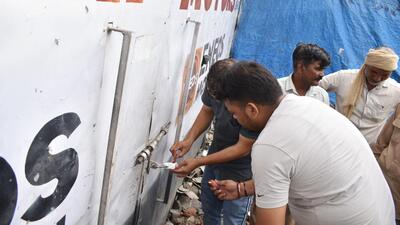 Officials of the Karnal municipal corporation sealing a property on Thursday. (HT Photo)