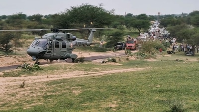 People gather as an Indian Air Force (IAF) chopper lands at an area where an IAF Jaguar Trainer aircraft crashed, killing two pilots, in Churu. (PTI) People gather as an Indian Air Force (IAF) chopper lands at an area where an IAF Jaguar Trainer aircraft crashed, killing two pilots, in Churu. (PTI)