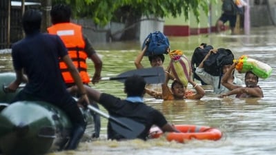 Rescue personnel assist locals in moving to a safer place through a rescue boat in a flood-affected area amid heavy rainfall on the outskirts of Agartala, Tripura. (PTI) Rescue personnel assist locals in moving to a safer place through a rescue boat in a flood-affected area amid heavy rainfall on the outskirts of Agartala, Tripura. (PTI)