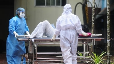 Health workers wearing protective gears shift a man with symptoms of Nipah virus to an isolation ward at a government hospital, in Kozhikode (AFP/File) Health workers wearing protective gears shift a man with symptoms of Nipah virus to an isolation ward at a government hospital, in Kozhikode (AFP/File)