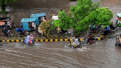 Commuters cross a flooded street after heavy monsoon rains in Lahore on July 9, 2025. (AFP) Commuters cross a flooded street after heavy monsoon rains in Lahore on July 9, 2025. (AFP)