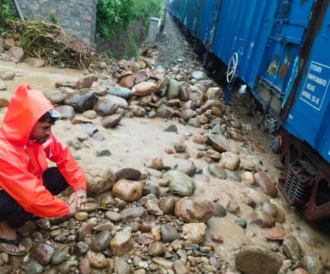 A man waits along the freight train that was held up for two hours after a rain-triggered mudslide led to its engine derailing near Lakhanpur on Thursday morning. (HT Photo) A man waits along the freight train that was held up for two hours after a rain-triggered mudslide led to its engine derailing near Lakhanpur on Thursday morning. (HT Photo)