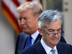 President Donald Trump looks on as Jerome Powell walks away