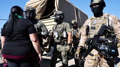 Federal agents block people protesting an ICE immigration raid at a nearby licensed cannabis farm on July 10, 2025 near Camarillo, California. (Mario Tama/AFP) Federal agents block people protesting an ICE immigration raid at a nearby licensed cannabis farm on July 10, 2025 near Camarillo, California. (Mario Tama/AFP)