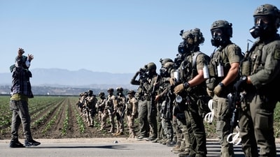 Federal agents block people protesting an ICE immigration raid at a nearby licensed cannabis farm on July 10, 2025 near Camarillo, California. (Mario Tama/AFP) Federal agents block people protesting an ICE immigration raid at a nearby licensed cannabis farm on July 10, 2025 near Camarillo, California. (Mario Tama/AFP)