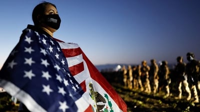 A demonstrator waves an American-Mexican flag near National Guard members and federal agents blocking protestors during an ICE immigration raid at a nearby licensed cannabis farm on July 10, 2025 near Camarillo, California. (AFP) A demonstrator waves an American-Mexican flag near National Guard members and federal agents blocking protestors during an ICE immigration raid at a nearby licensed cannabis farm on July 10, 2025 near Camarillo, California. (AFP)