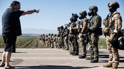 Federal agents block people protesting an ICE immigration raid at a nearby licensed cannabis farm on July 10, 2025 near Camarillo, California. (AFP) Federal agents block people protesting an ICE immigration raid at a nearby licensed cannabis farm on July 10, 2025 near Camarillo, California. (AFP)