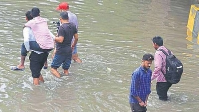 People wading through knee-deep water in Narsinghpur village in Gurugram on Wednesday. (Parveen Kumar/ Hindustan Times) People wading through knee-deep water in Narsinghpur village in Gurugram on Wednesday. (Parveen Kumar/ Hindustan Times)