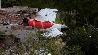 Tail of an Air India Boeing 787 Dreamliner plane that crashed is seen stuck on a building after the incident in Ahmedabad. (REUTERS )