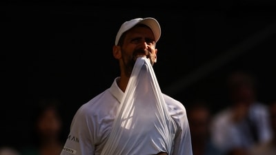 Serbia's Novak Djokovic bites his jersey as he plays against Italy's Jannik Sinner during their men's singles semi-final tennis match on the twelfth day of the 2025 Wimbledon Championships at The All England Lawn Tennis and Croquet Club in Wimbledon, southwest London, on July 11, 2025. (Photo by HENRY NICHOLLS / AFP) / RESTRICTED TO EDITORIAL USE (AFP) Serbia's Novak Djokovic bites his jersey as he plays against Italy's Jannik Sinner during their men's singles semi-final tennis match on the twelfth day of the 2025 Wimbledon Championships at The All England Lawn Tennis and Croquet Club in Wimbledon, southwest London, on July 11, 2025. (Photo by HENRY NICHOLLS / AFP) / RESTRICTED TO EDITORIAL USE (AFP)