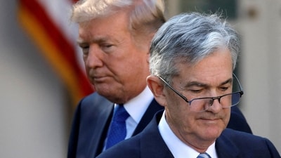 President Donald Trump looks on as Jerome Powell walks away (REUTERS)