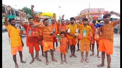 Young Deepak on his maiden Kanwar Yatra along with his father and neighbours at Dashashwamedh Ghat on Friday morning. (HT Photo) Young Deepak on his maiden Kanwar Yatra along with his father and neighbours at Dashashwamedh Ghat on Friday morning. (HT Photo)