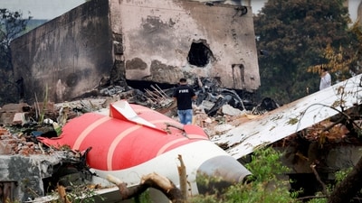 A firefighter stands next to the crashed Air India Boeing 787 Dreamliner aircraft, in Ahmedabad. (Reuters)