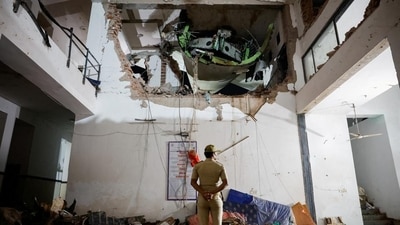 A police officer stands in front of the wreckage of the Ahmedabad-London Gatwick Air India 171 aircraft that crashed shortly after take-off. (HT) A police officer stands in front of the wreckage of the Ahmedabad-London Gatwick Air India 171 aircraft that crashed shortly after take-off. (HT)