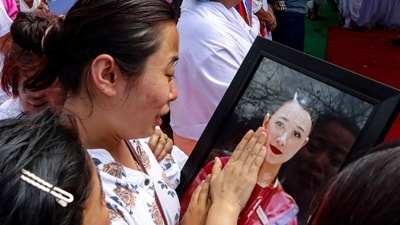 Sister of plane crash victim Kongbrailatpam Nganthoi Sharma, a cabin crew member of the AI 171, mourns during her funeral ceremony in Imphal. (AFP) Sister of plane crash victim Kongbrailatpam Nganthoi Sharma, a cabin crew member of the AI 171, mourns during her funeral ceremony in Imphal. (AFP)