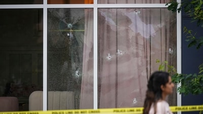 Bullet holes are seen in the windows of a cafe, in Surrey, British Columbia, , as Surrey Police investigate shots that were fired at Kap's Cafe, (AP) Bullet holes are seen in the windows of a cafe, in Surrey, British Columbia, , as Surrey Police investigate shots that were fired at Kap's Cafe, (AP)