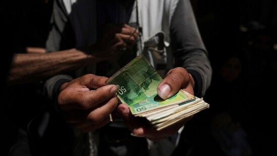 The bills in Gaza are tattered after 21 months of war. (Jehad Alshrafi/ AP)