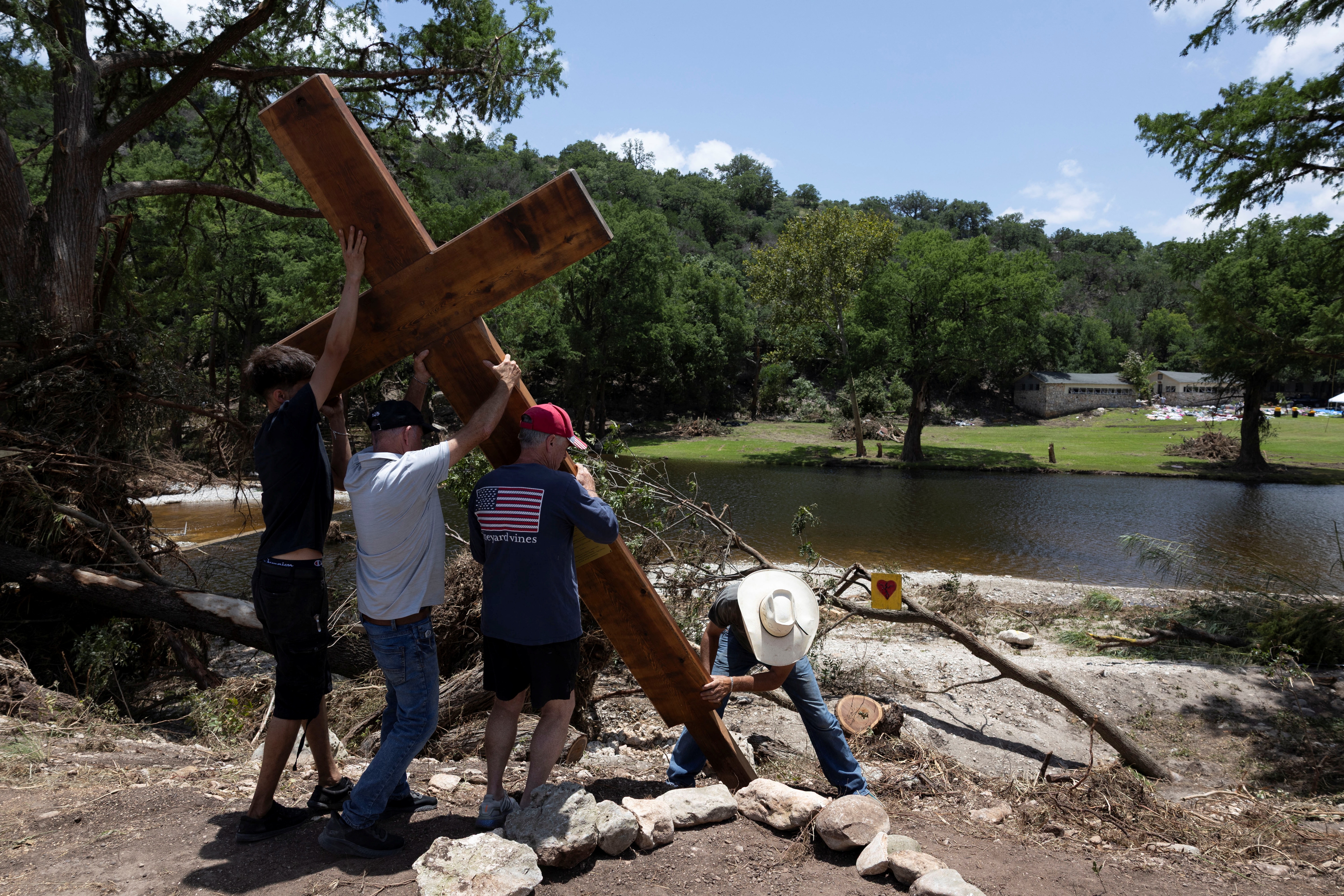 A cross is placed by the Guadalupe River across from Camp Mystic in Hunt, Texas, honoring lives lost in the deadly flood. REUTERS/Umit Bektas     TPX IMAGES OF THE DAY (REUTERS)