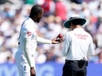 England's Jofra Archer holds the ball as he inspects with umpire Sharfuddoula Saikat