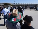 People gather outside of Glass House Farms, a day after an immigration raid on the facility, on Friday. People gather outside of Glass House Farms, a day after an immigration raid on the facility, on Friday.