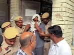 The Father of the deceased Radhika Yadav, accused Deepak Yadav being brought out of the court and taken to a one-day Police remand after the court's order, in Gurugram on Friday. 