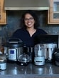 Swetha Sivakumar with some of her toys: a panini maker, small grinder, food processor, electric pressure cooker, egg poacher, air fryer, two blenders and a small chopper. Swetha Sivakumar with some of her toys: a panini maker, small grinder, food processor, electric pressure cooker, egg poacher, air fryer, two blenders and a small chopper.