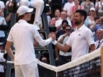 Italy's Jannik Sinner shakes hands with Serbia's Novak Djokovic.