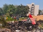 People look at the debris of the Air India plane that crashed moments after taking off from the airport, in Ahmedabad on June 12. People look at the debris of the Air India plane that crashed moments after taking off from the airport, in Ahmedabad on June 12.