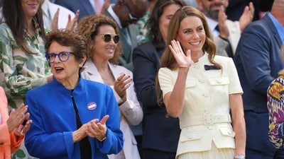 Princess Kate wore a pleated midi skirt and a structured white shirt with short sleeves and a belt. She accessorized the ensemble with beige heels, a similar straw purse known as an Anya Hindmarch Tote, and a wristwatch. (AP) Princess Kate wore a pleated midi skirt and a structured white shirt with short sleeves and a belt. She accessorized the ensemble with beige heels, a similar straw purse known as an Anya Hindmarch Tote, and a wristwatch. (AP)