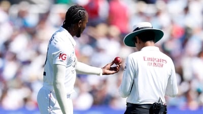 England's Jofra Archer holds the ball as he inspects with umpire Sharfuddoula Saikat (Action Images via Reuters)