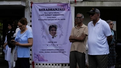 People stand next to a condolence banner as they wait for the body of Sumeet Sabharwal, a pilot who died when an Air India Boeing 787-8 Dreamliner crashed during take-off. (REUTERS file)
