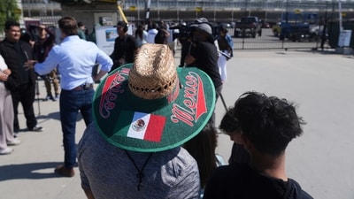 People gather outside of Glass House Farms, a day after an immigration raid on the facility, on Friday. (AP) People gather outside of Glass House Farms, a day after an immigration raid on the facility, on Friday. (AP)