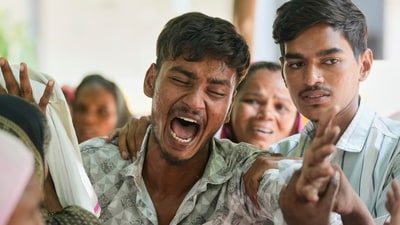 Relatives of the Ahmedabad plane crash victims at the site on June 12. (AP File) Relatives of the Ahmedabad plane crash victims at the site on June 12. (AP File)