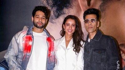 Actors Siddhant Chaturvedi and Tripti Dimri with Karan Johar during the trailer launch of Dhadak 2. (PTI)