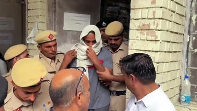 The Father of the deceased Radhika Yadav, accused Deepak Yadav being brought out of the court and taken to a one-day Police remand after the court's order, in Gurugram on Friday. (ANI ) The Father of the deceased Radhika Yadav, accused Deepak Yadav being brought out of the court and taken to a one-day Police remand after the court's order, in Gurugram on Friday. (ANI )