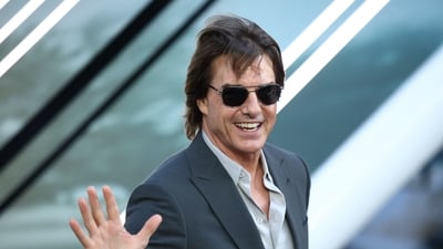 US actor Tom Cruise gestures upon arrival for the European Premier of F1 The Movie, at Cineworld Leicester Square, central London, on June 23, 2025. (Photo by HENRY NICHOLLS / AFP) (AFP)