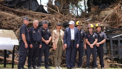 First lady Melania Trump, center left, and President Donald Trump, center right, pose with first responders as they observe flood damage in Kerrville, Texas, Friday, July 11, 2025. (AP Photo/Jacquelyn Martin) (AP) First lady Melania Trump, center left, and President Donald Trump, center right, pose with first responders as they observe flood damage in Kerrville, Texas, Friday, July 11, 2025. (AP Photo/Jacquelyn Martin) (AP)