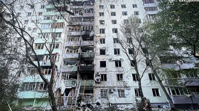 Firefighters and a police officer work at the site of an apartment building damaged during Russian drone and missile strikes (REUTERS)
